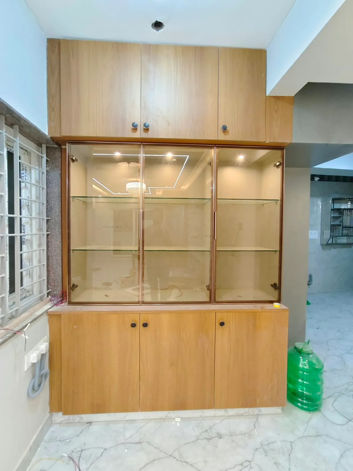 Avenza project work: Dining crockery display unit with bronze profile glass doors