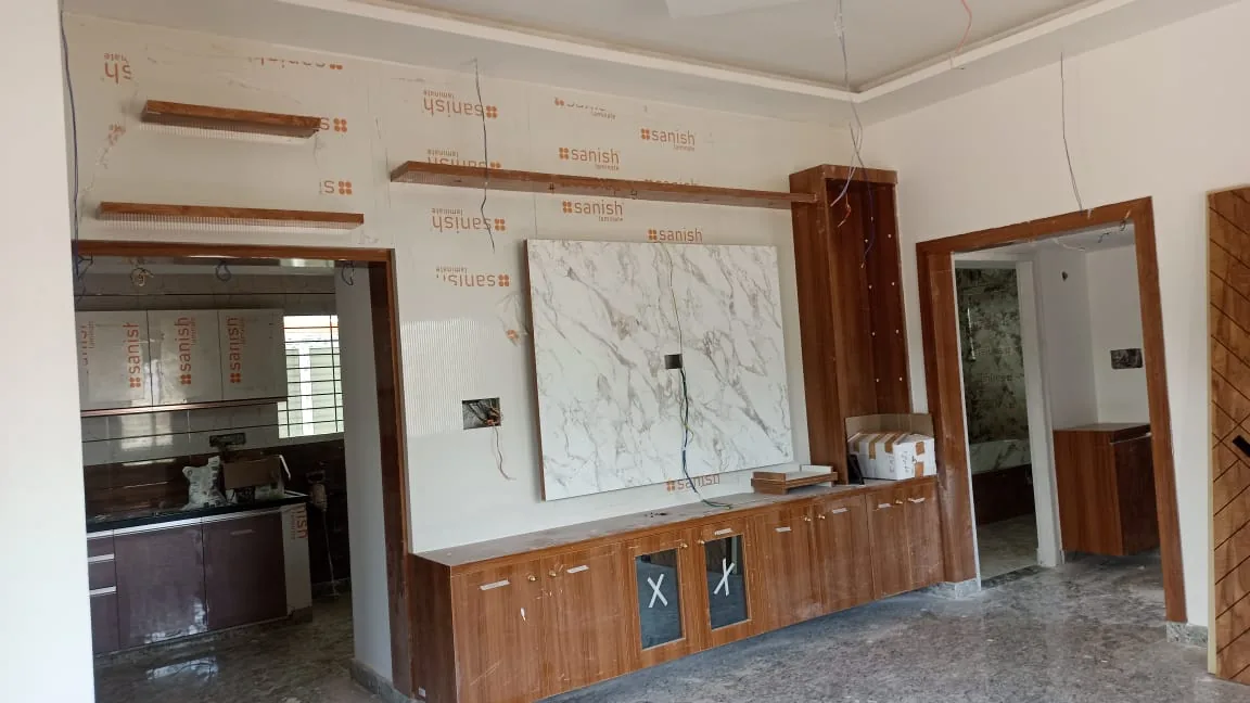 On-site work: Media wall TV unit installation with marble panel and console