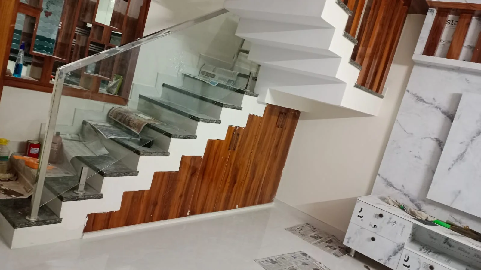 On-site work: Cantilevered staircase glass railing and stepped under-stair storage